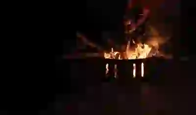 Student stoking a fire at UC